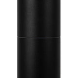 A tall, cylindrical matte black object resembling the Koln LED Bollard Light 65cm - Black. Its smooth surface with a faint horizontal seam suggests a detachable top for accessing the LED module. Set against a plain white background, it hints at sophisticated outdoor lighting.
