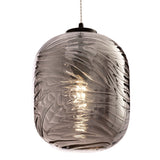 The Dunas Oblong Pendant Light - Black with Smoked Patterned Glass casts a warm glow, enhancing its swirling patterns. Its contemporary design and stylish cord make it perfect for modern spaces.