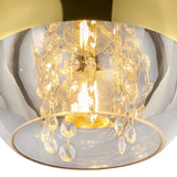 The Fermi Small Dome Pendant Light showcases an elegant and modern design with crystal accents and a glowing bulb encased in shiny gold, resembling a chandelier that brings luxurious warmth to any space.