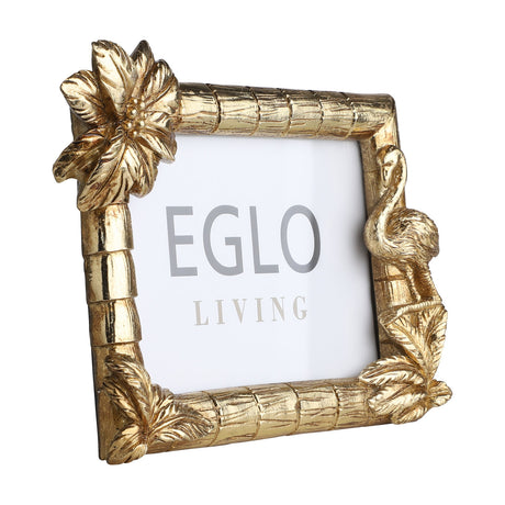 Esashi Photo Frame in gold polyresin with bamboo-textured border, featuring a palm flower at one corner and a flamingo among leaves at another, glass front, shown on a plain white background.