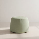 Esen Upholstered Outdoor Pouffe, Ø60cm, a round tapered sage green fabric drum with a top seam, shown against a plain neutral background.