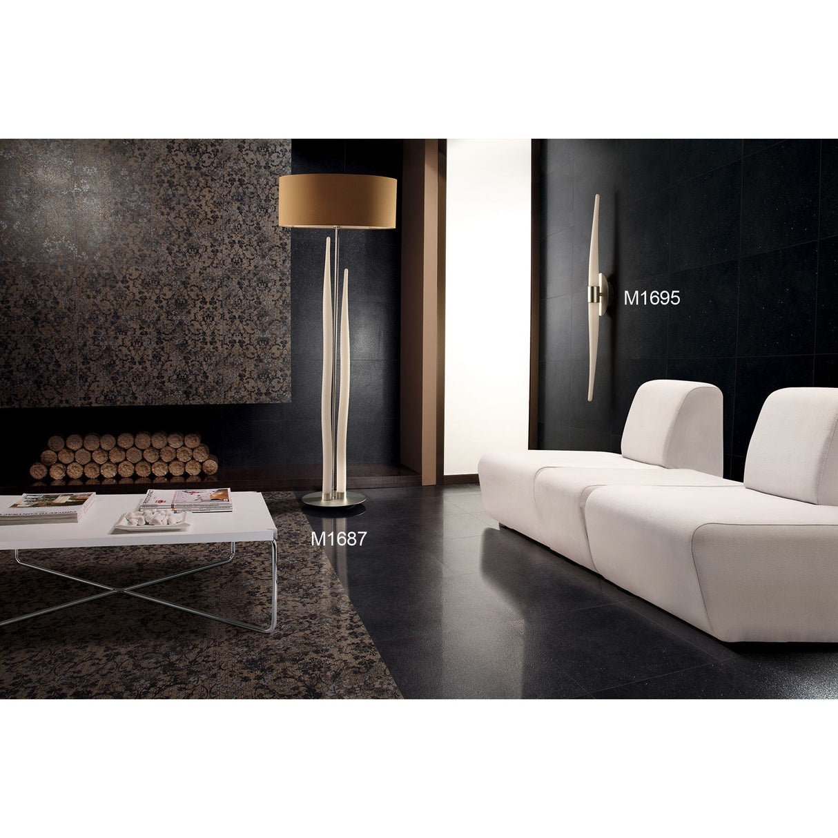 Modern living room with dark stone walls, floor, white minimalist sofa, white coffee table with magazines, Estalacta 3 Light Floor Lamp - Silver With Black Shade as a statement piece. Neatly stacked firewood in the background.