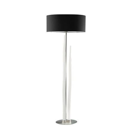 The Estalacta 3 Light Floor Lamp features a round black shade, two tall white curved stems, and a circular silver base—a striking statement piece for modern interiors, shown against a plain white background.