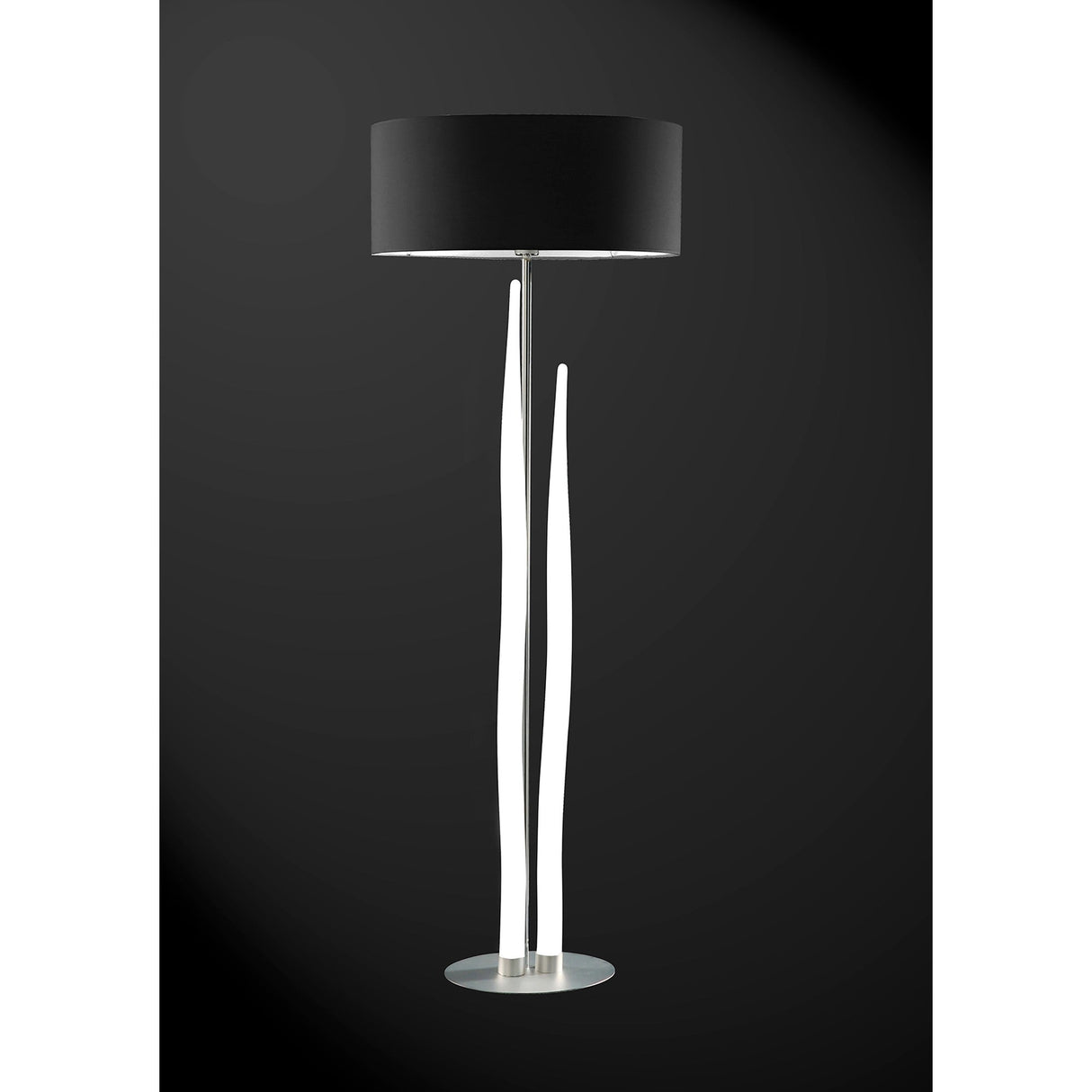 The Estalacta 3 Light Floor Lamp features a sleek silver base, black drum shade, and artistic white wavy supports—a striking statement piece that adds modern flair to any room.