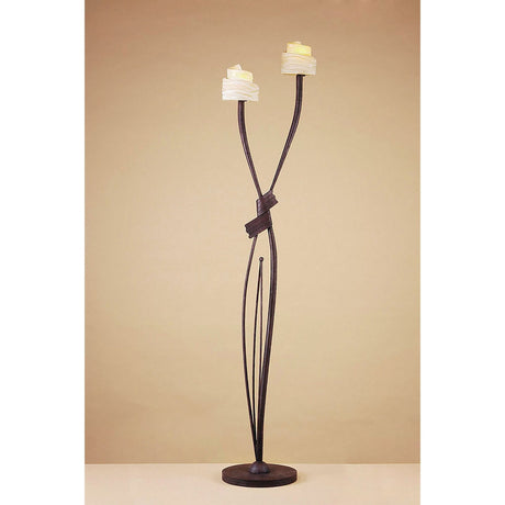 The Estilo 2 Light Floor Lamp in Brown & Black Oxide features two upward-curving arms with amber frosted glass candle-shaped shades on a dark metal frame, offering ambient lighting against a beige background.