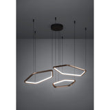 Estrella Pendant Light with three bronze hexagonal LED rings at varying heights from a black ceiling canopy on fine cables, against a plain grey background.