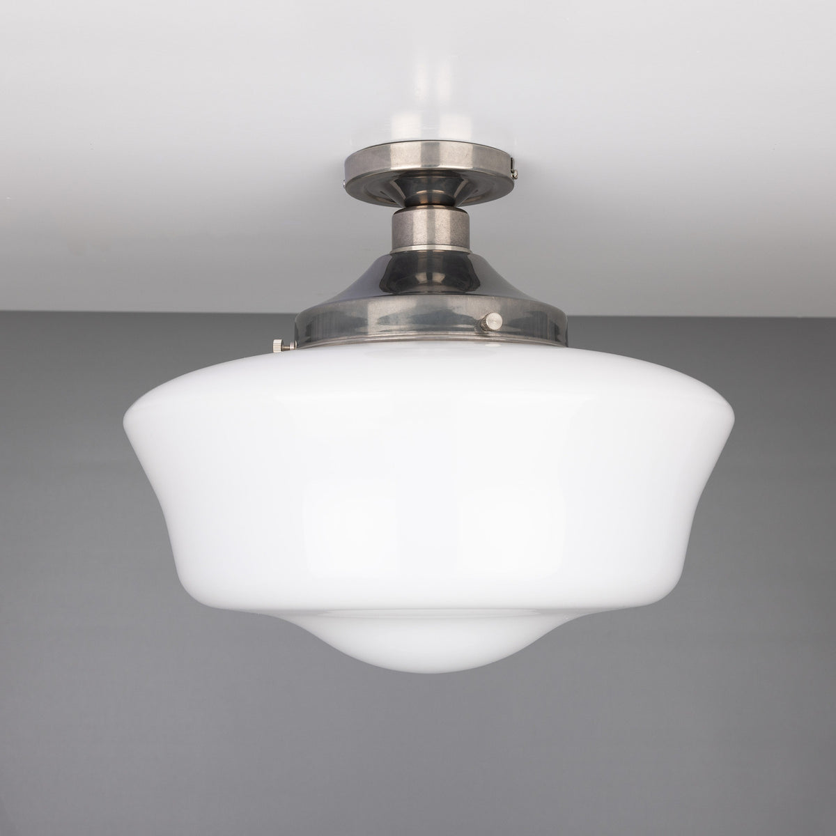 Ethrina Glass Semi Flush Ceiling Light with white opal schoolhouse-style glass shade on a short stem from a round antique silver ceiling plate, shown against a plain grey background.