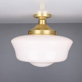 Ethrina Glass Semi Flush Ceiling Light with a white opal schoolhouse-style glass shade and satin brass fitter and ceiling plate, shown against a plain grey background.