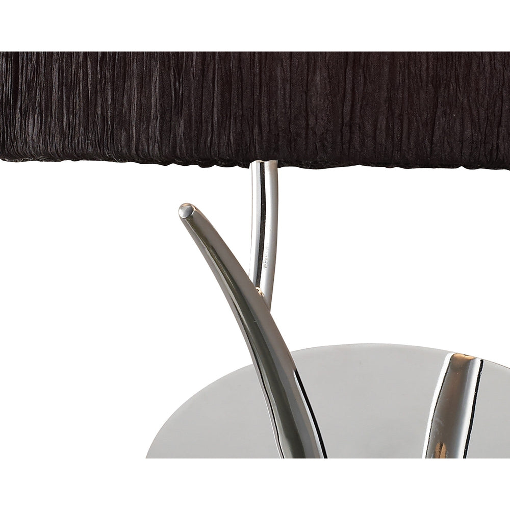 Close-up of Eve wall light showing the polished chrome curved arm and circular backplate beneath the textured black fabric shade.