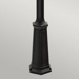 A close-up view of the Firenze 3 Light Lamp Post in black, featuring a hexagonal base with decorative panels and a sleek black finish, ideal for enhancing an outdoor space against a light gray background.