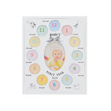 Silver metal multi-aperture photo frame with twelve numbered round openings labelled 1st to 12th month around a central oval photo space reading "Baby's First Year," shown on a white background.