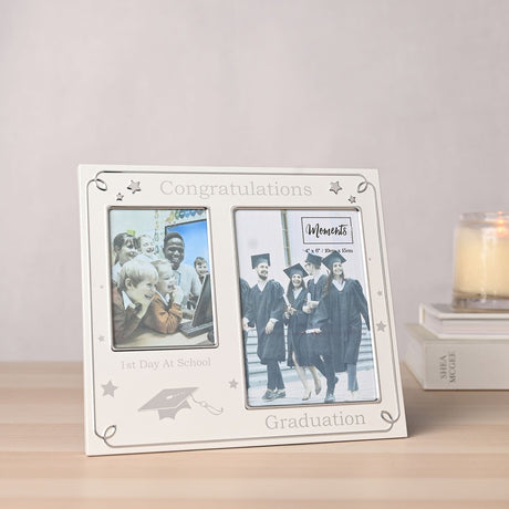Silver aluminium double photo frame with "Congratulations" text, star details and mortarboard icon, labelled "1st Day At School" and "Graduation", displayed on a wooden surface.
