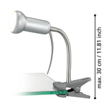 Fabio Clip On Lamp in silver with rounded spot head, flexible gooseneck arm and spring clip base, shown on a glass shelf edge with height measurement of max 30cm against a white background.