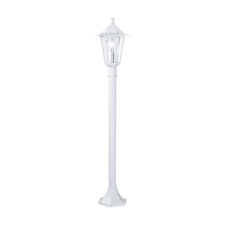 Fasvette white bollard light with a slim lamp-post design, six-sided lantern head, clear glass panels, finial, and a tall round pole on a flared hexagonal base.