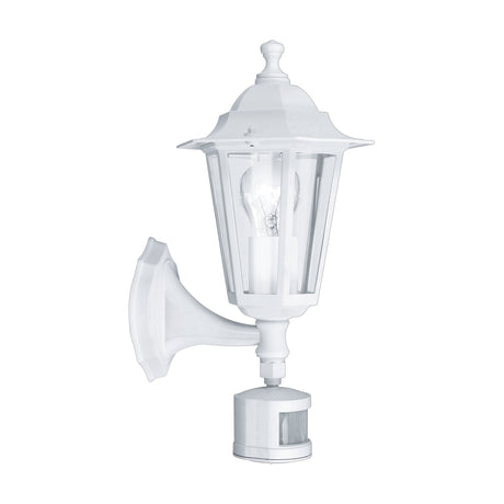 Fasvette white cast aluminium outdoor wall light, six-sided lantern with clear glass panels, visible bulb, curved wall bracket and motion sensor, shown on a plain white background.