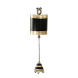 The Phoenician 1 Light Table Lamp in Black, Gold, and Silver Leaf features a decorative, vertical design with a bell-like shape. The lamp has a gold and black cylindrical top adorned with ornate scroll details. A long stem leads to its conical base, which is striped and sits on small ball feet, all enhanced by the subtle elegance of Silver Leaf accents.