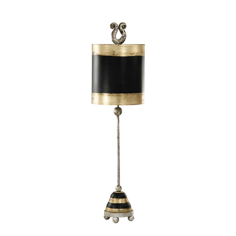 The Phoenician 1 Light Table Lamp in Black, Gold, and Silver Leaf features a decorative, vertical design with a bell-like shape. The lamp has a gold and black cylindrical top adorned with ornate scroll details. A long stem leads to its conical base, which is striped and sits on small ball feet, all enhanced by the subtle elegance of Silver Leaf accents.