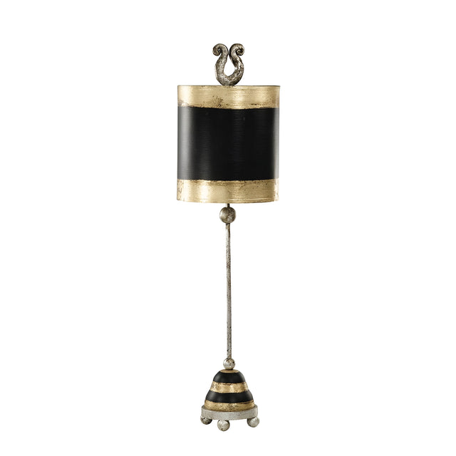 The Phoenician 1 Light Table Lamp in Black, Gold, and Silver Leaf features a decorative, vertical design with a bell-like shape. The lamp has a gold and black cylindrical top adorned with ornate scroll details. A long stem leads to its conical base, which is striped and sits on small ball feet, all enhanced by the subtle elegance of Silver Leaf accents.