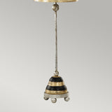 A metallic ornament resembling the Silver Leaf design, shaped like a bell with alternating black and silver stripes, is suspended by a thin rod. The bottom of the bell is accented with four small, rounded silver knobs. It shares similarities with the Phoenician 1 Light Table Lamp - Black, Gold & Silver Leaf. The backdrop features a plain, light gray color.