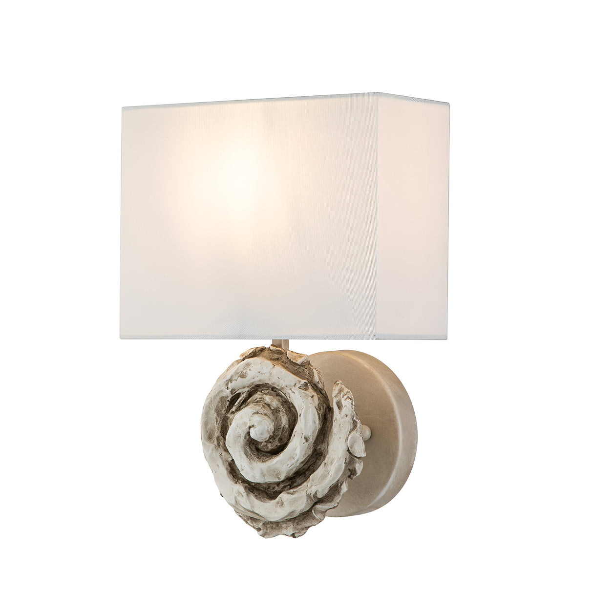 The Swirl 1 Light Large Wall Light - White is a wall-mounted fixture featuring a square white lampshade and a decorative base with a swirl shell-like design in a rustic, textured finish. It casts a warm glow when illuminated.