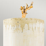 A ceramic vase with a textured cream-colored surface and brown drips showcases a hand-painted putty patina finish, complemented by an intricately shaped ceramic branch emerging from the top against a light gray background, similar to the Trellis 1 Light Wall Light featuring Putty Patina & Silver Leaf.