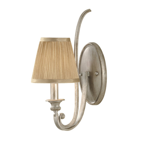 The Abbey 1 Light Wall Light in Silver Sand boasts a decorative gold shade and a metallic finish. Its design includes a curved arm and an oval backplate, offering a classic and elegant look that pairs beautifully with the Abbey 3 Light Chandelier.