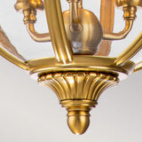 Here is a revised version of the sentence using the product data:

A close-up view of the Adams 3 Light Chandelier in burnished brass showcases its ornate, curved metal bars and intricate detailing. The Victorian design lighting enhances elegance with a smooth, polished finish, making it a luxurious fixture that adds sophistication to any space.
