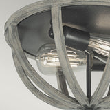 A close-up of the Allier 2 Light Flush showcases its rustic design with exposed Edison bulbs. The orb-shaped fixture, constructed from weathered oak wood and accented with antique forged iron, emphasizes the glowing filaments against a neutral backdrop.