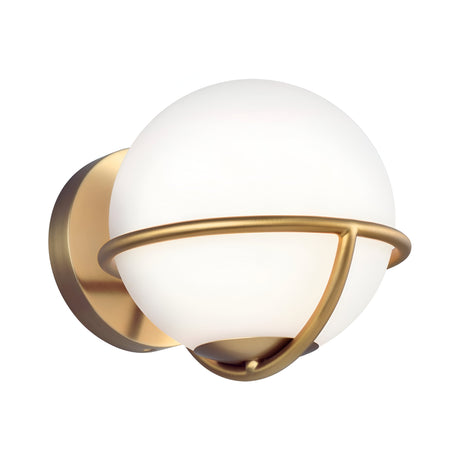 The Apollo 1 Light Wall Light - Burnished Brass is a contemporary wall fixture that showcases an opal glass globe-shaped shade, complemented by a streamlined burnished brass frame. The design incorporates a circular mount with geometric elements surrounding the globe, delivering both elegance and sophistication.