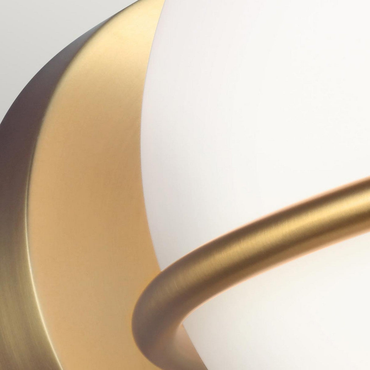 Close-up of the Apollo 1 Light Wall Light - Burnished Brass, showcasing a spherical shade made of white opal glass with elegant burnished brass accents, set against a gradient background. The design highlights sleek curves and a minimalist aesthetic.