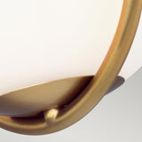 Close-up of the Apollo 1 Light Wall Light - Burnished Brass highlighting its opal glass shade and elegant burnished brass frame. The minimalistic design features smooth, curved lines and a slightly soft-focus appearance.