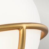 Close-up of the Apollo 1 Light Wall Light in burnished brass, showcasing an opal glass spherical lampshade coupled with a sleek, curved frame. The minimalist design emphasizes soft lighting and smooth textures.