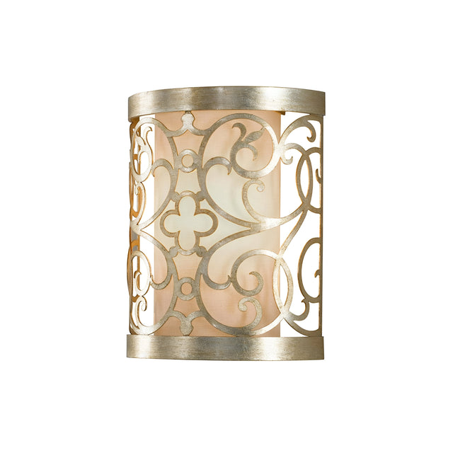 Introducing the Arabesque 1 Light Wall Light - Silver Leaf Patina: This beautifully crafted wall sconce features a metallic frame with intricate laser-cut scrollwork and a floral pattern. The semi-circular design, adorned with a silver leaf patina, diffuses warm light softly to enhance any space with elegance and decorative charm.