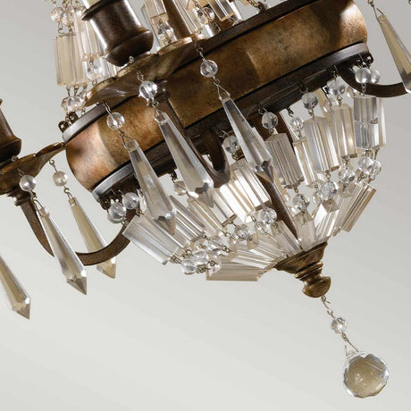 Close-up of the Bellini 4 Light Chandelier in Oxidized Bronze/British Bronze, an elegant piece adorned with antique quartz crystal prisms and pendants hanging from an ornate frame. The crystals reflect light, creating a sparkling effect against a soft, neutral background.