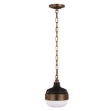 Introducing the Cadence 1 Light Mini Pendant in Dark Antique Brass and Matte Black. This elegant fixture boasts a round, modern design with a white glass shade at its base. It hangs from a brass chain attached to the ceiling mount, offering a vintage-industrial charm to any room.