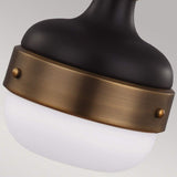 A close-up of the Cadence 1 Light Mini Pendant showcases its black and bronze body with a white frosted glass shade. This fixture embodies an industrial lighting style, featuring decorative screws that secure a bronze band around the glass for a vintage-industrial feel.