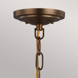 The Cadence 2 Light Pendant in Dark Antique Brass and Matte Black showcases its industrial pendant lighting with a centrally suspended chain and cord against a neutral backdrop. The fixture features an aged finish, enhancing the classic charm of its vintage-inspired design.
