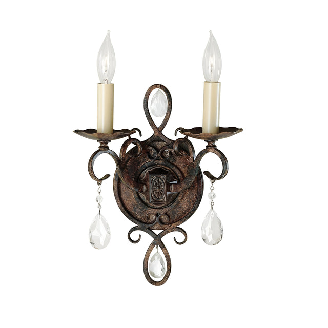 The Chateau 2 Light Wall Light - Mocha Bronze is an elegant decorative wall sconce featuring two candle-shaped bulbs. Its ornate metal design in a Mocha Bronze finish showcases intricate scrolls and crystal accents, lending a vintage charm. The circular base is adorned with detailed craftsmanship and crystal-like pendants for added sophistication.