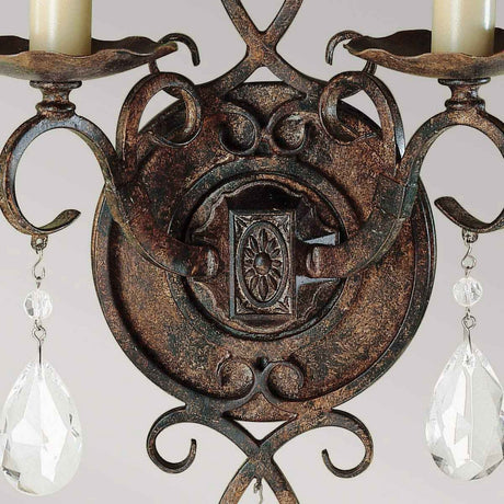 Close-up of the Chateau 2 Light Wall Light - Mocha Bronze, featuring ornate candle holders. The design highlights intricate metalwork with swirling patterns and circular motifs, embellished by crystal accents. This enchanting piece is finished with a rustic Mocha Bronze coating, adding a touch of timeless elegance.