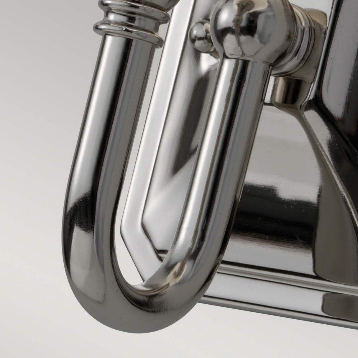 A close-up of the Concord 1 Light Wall Light - Polished Chrome reveals its curved design, accentuating the reflective surface and smooth contours. The opal-etched glass shade enhances its modern and sleek aesthetic.