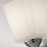 Close-up of the Concord 1 Light Wall Light - Polished Chrome, showcasing its modern square lampshade with a smooth, opal-etched glass shade. The polished chrome base enhances the sleek, contemporary design of the lamp, which is set against a neutral background to highlight its stylish appeal.