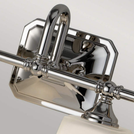 Close-up of the Concord 4 Light Wall Light - Polished Chrome, showcasing its sleek curved design with a rectangular backplate. The modern, reflective surface elegantly captures surrounding light and shadows, beautifully accented by opal-etched glass shades.