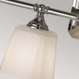 Close-up of the Concord 4 Light Wall Light - Polished Chrome, featuring a sleek metallic frame and an opal-etched glass shade. The fixture is turned off, allowing its elegant design to stand out against a neutral background.