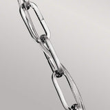 Close-up of the Corinne 3 Light Small Chandelier, featuring a polished nickel finish with sleek elongated links, set against a light gray background.