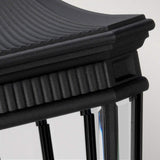Close-up of the Cotswold Lane 3 Light Outdoor Large Pedestal in black, featuring a ribbed, curved top with vertical clear glass panels. This lighting piece adds a classic and elegant touch with its intricate frame detailing.