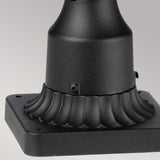 Close-up of the Cotswold Lane 3 Light Outdoor Large Pedestal in black, showcasing its decorative fluted design. The square metal base includes a small screw near the curved section, ideal for an outdoor pedestal light. The light gray background enhances the stunning black finish of this lighting piece beautifully.