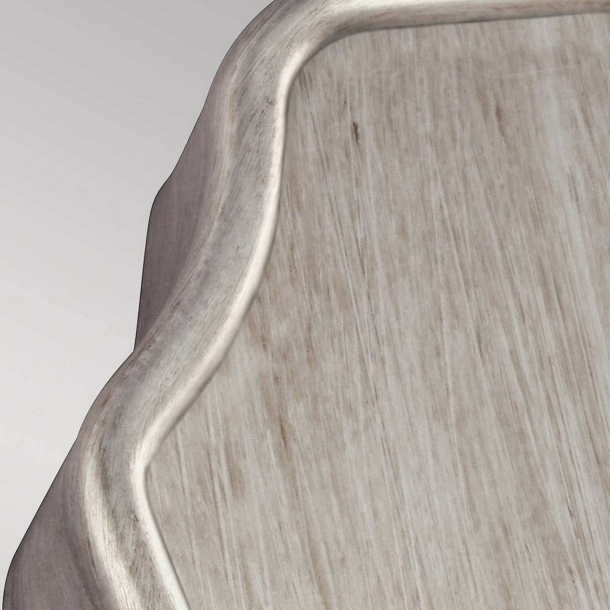 Close-up of the DeWitt 1 Light Wall Light in Sunrise Silver, featuring a textured, light wooden surface with a curved edge. The natural grain and smooth finish are highlighted, while the Sunrise Silver finish accentuates the wood's subtle, natural patterns for an elegant touch.