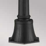 A close-up of a decorative black lamp post base highlights its sturdy, hexagonal structure with subtle grooves and rivet details. Its classic design wonderfully complements the English Bridle 3 Light Outdoor Medium Pillar - Black style against a plain gray background.