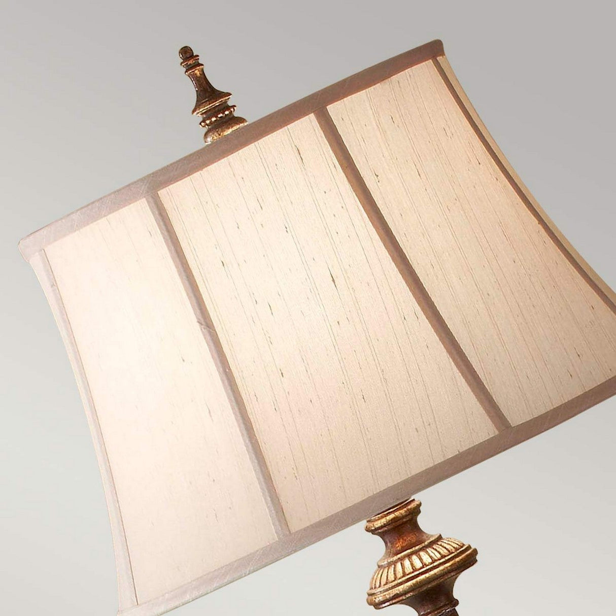 A close-up of the Gibson 1 Light Floor Lamp in dark brown, featuring a square desert linen fabric shade and a decorative antique-style brass base set against a neutral background.