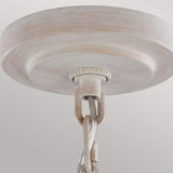 Close-up of the charming Hartsville 3 Light Chandelier in Chalk Washed/Beachwood, resembling a rustic chandelier with a round, wooden-like plate and chain link. Perfect for coastal casual spaces, it features an aged appearance with a light, weathered finish against a plain background.